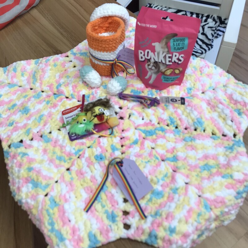 11. Handmade crochet start blanket & pill bottle, seafood-flavored treats, emoji toy, rainbow collar