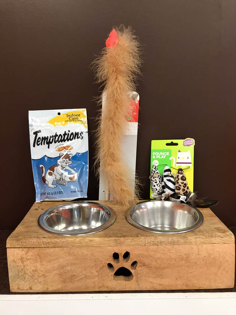 6. Raised wooden feeder with Temptations treats and catnip mice