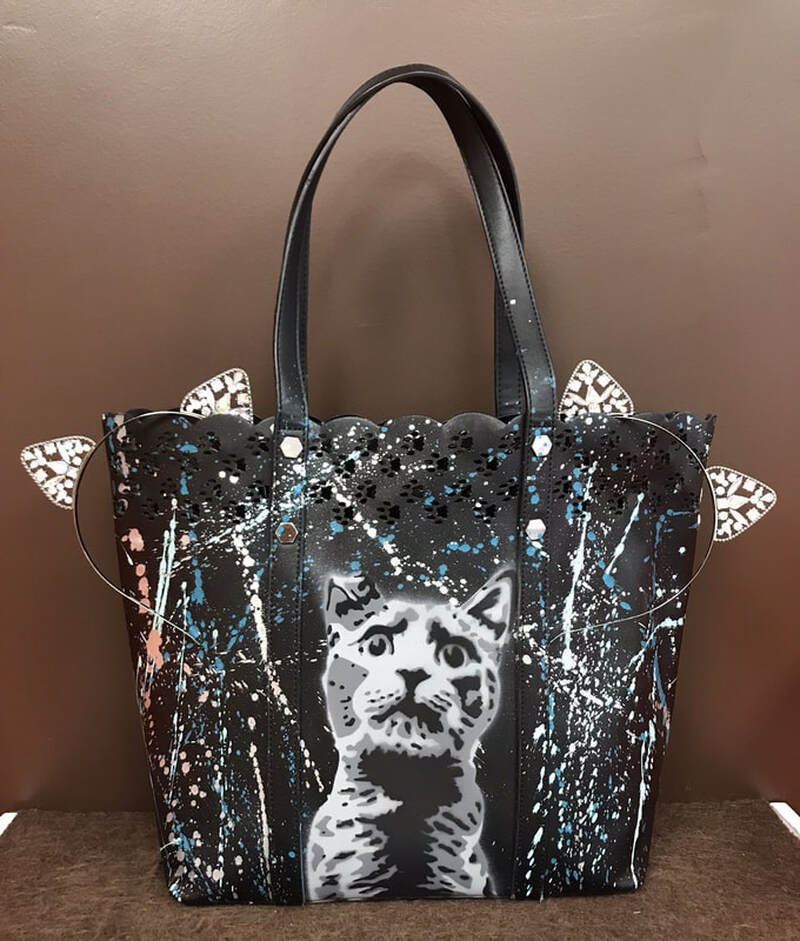 17. Black cat tote, cat scratcher, treats, toys, laser toy