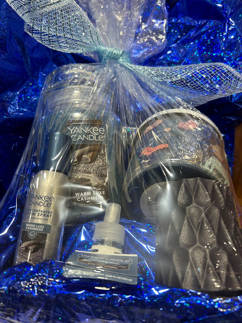 Raffle Prize #7: Large Yankee Candle, medium Yankee Candle with dog design, a concentrated room spray, plug-in with refill